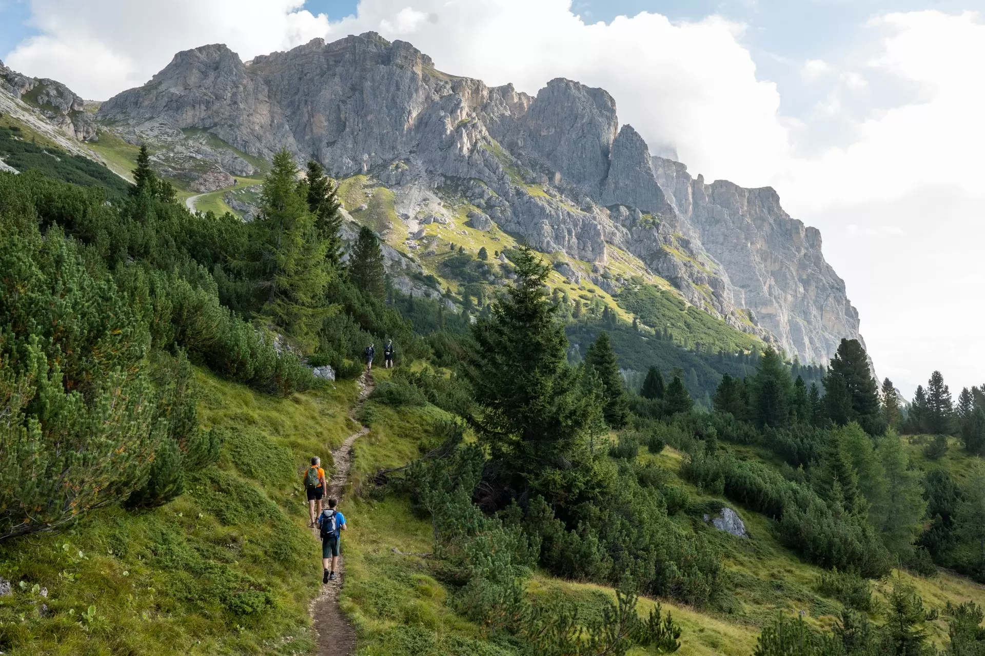 Hikers follow a mountain trail near Cortina d'Ampezzo in the Dolomites, Italy.