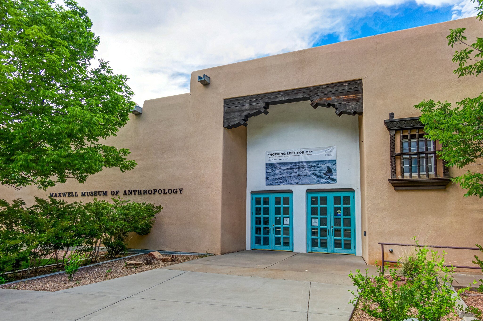 The teal entrance doors at the Maxwell Museum of Anthropology at the University of New Mexico