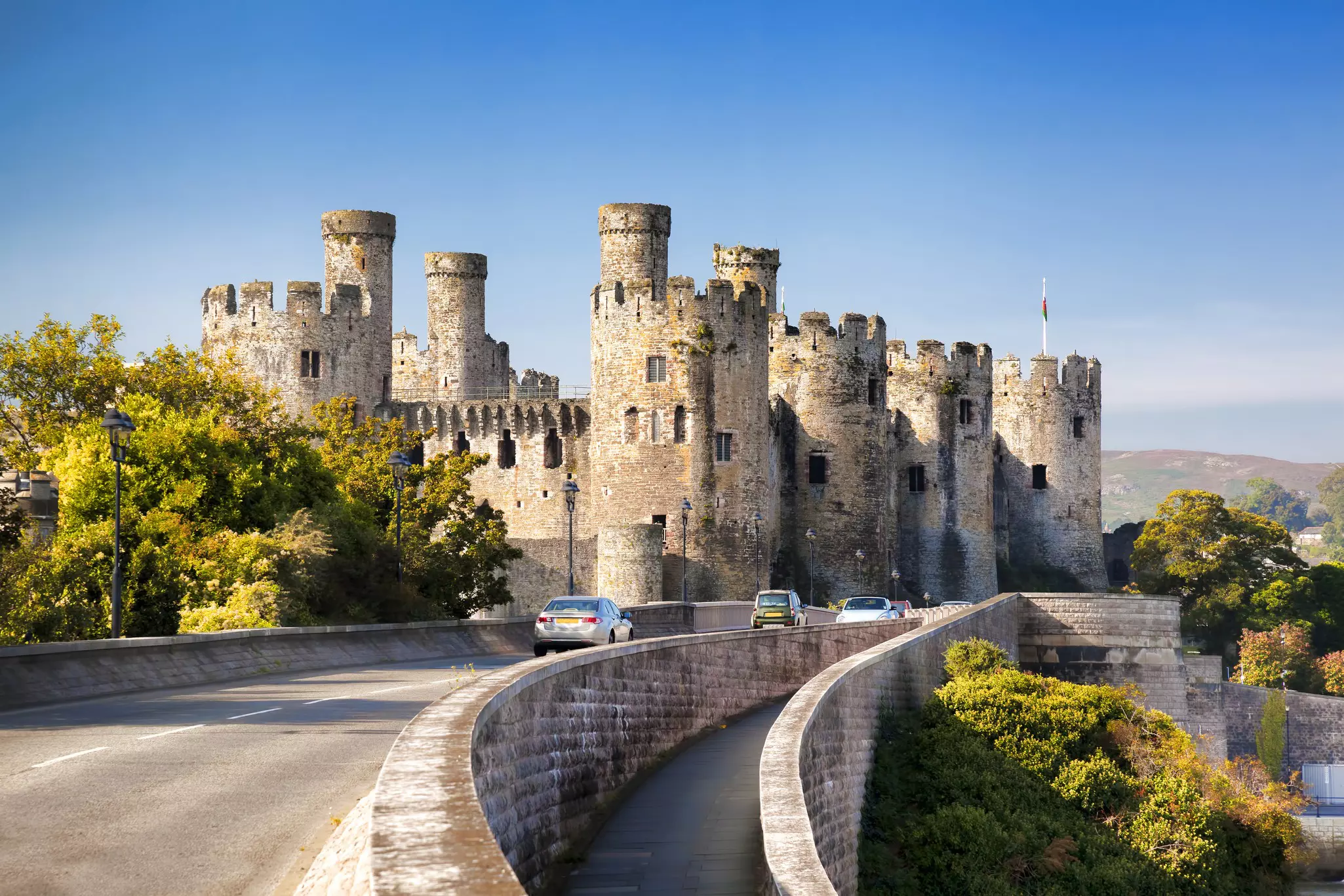 A road passing on front of Conwy Castle in Wales.