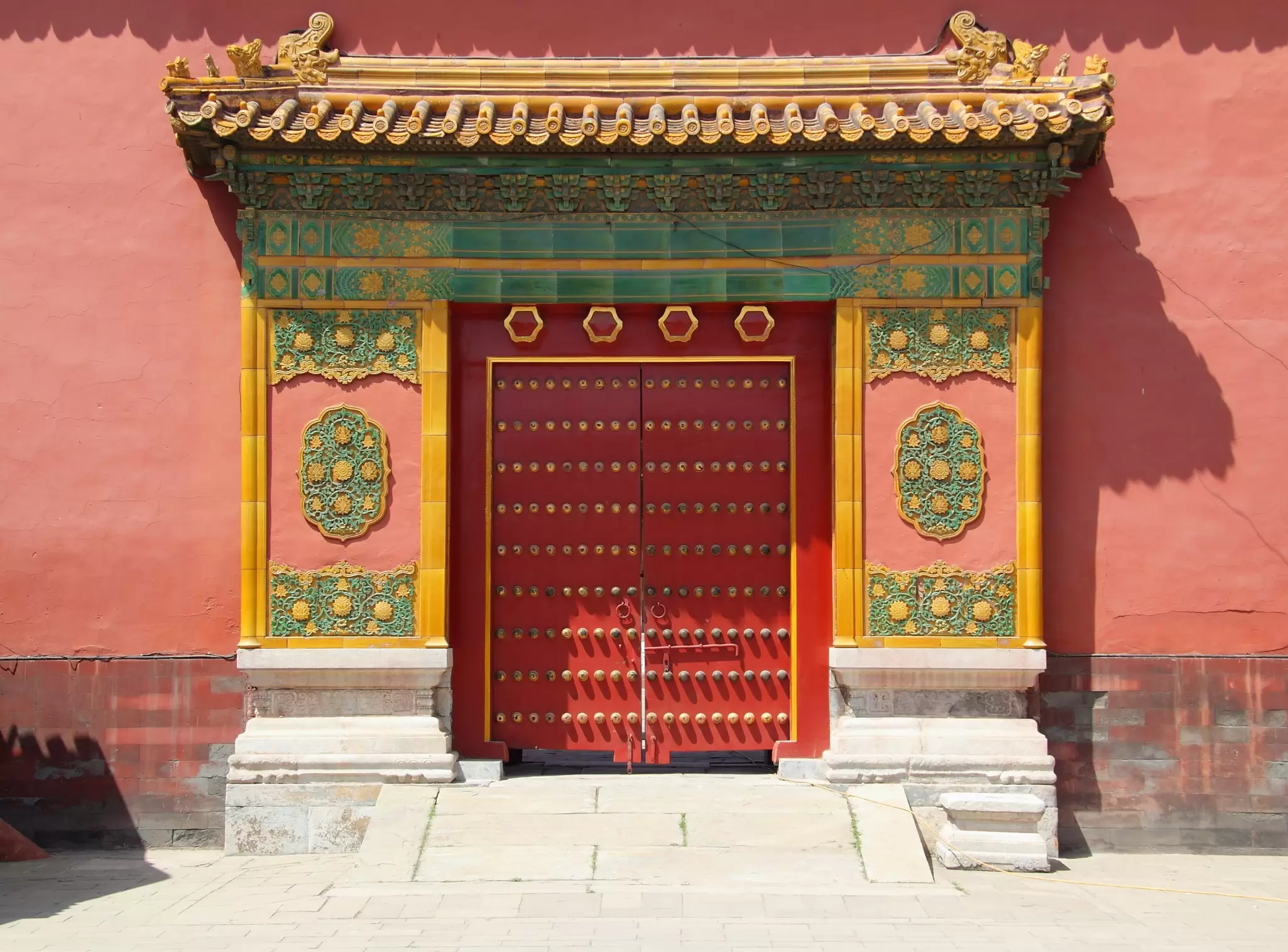 View of a colorful gate in the Forbidden City on a sunny day in Beijing, China,