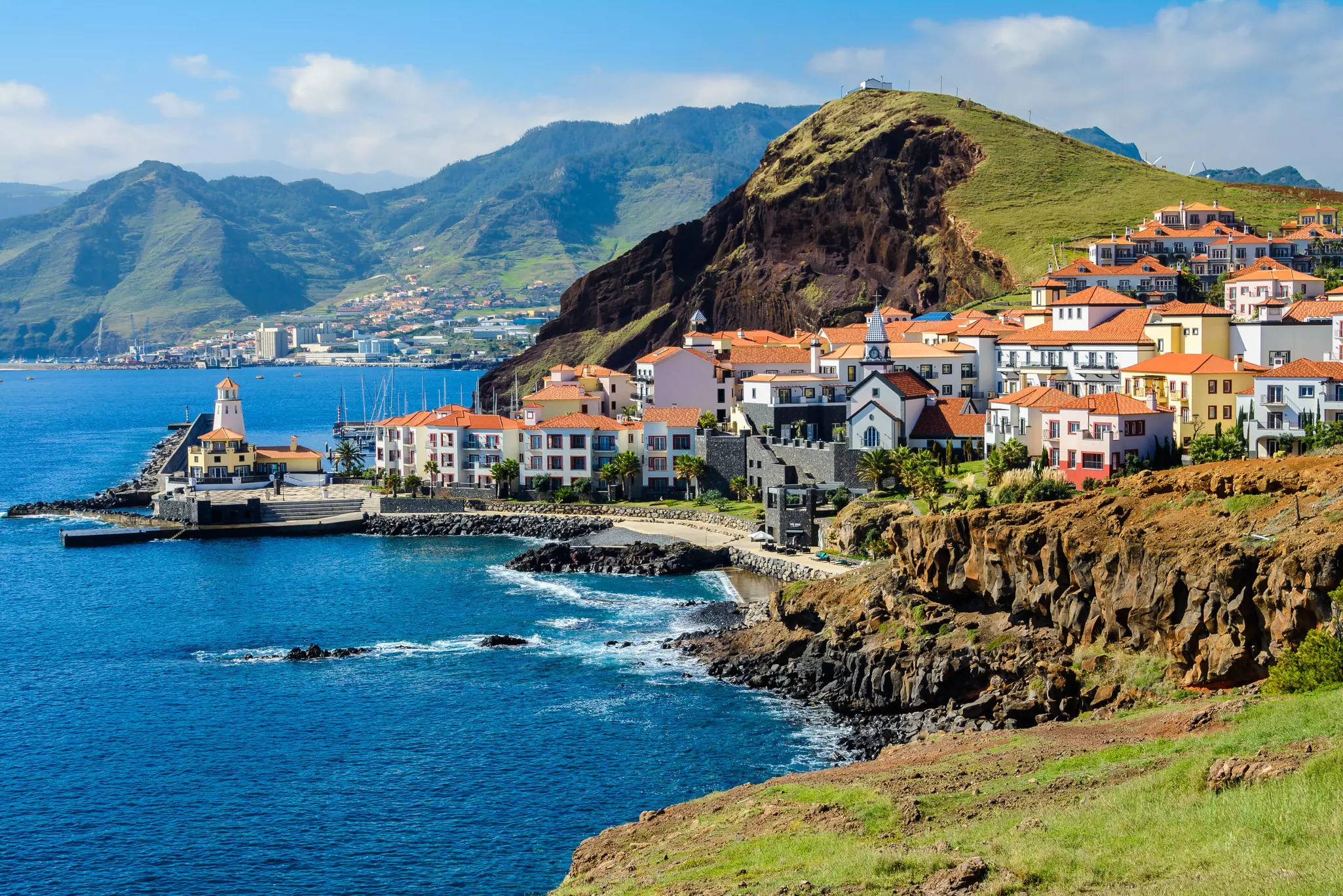 Cliffs and blue bays along the coast at Quinta Grande, Madeira, Portugal.