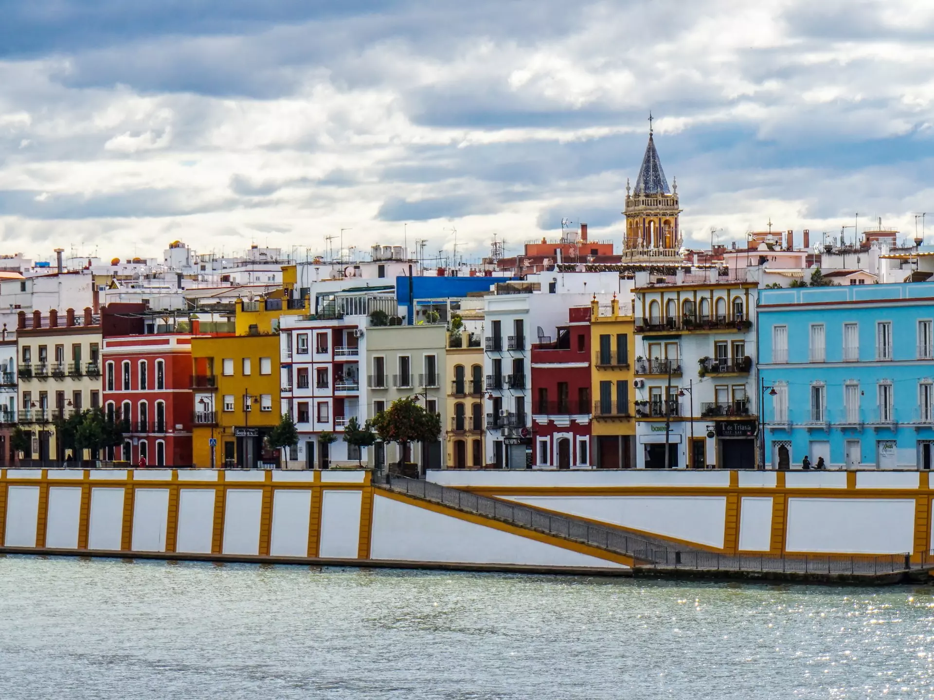 Multicolored buildings by a river.
