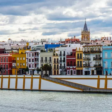 Multicolored buildings by a river.