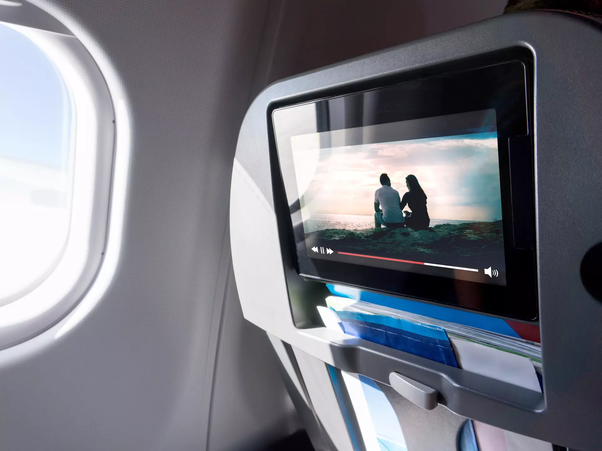 Watching movie on an airplane touch screen. Imaginary film playing on a video player in monitor during long flight. Entertainment service system in aircraft.