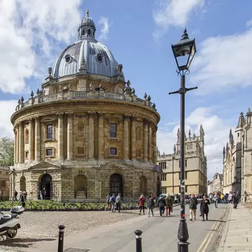616219462
Tourism, Radcliffe Camera, Oxford University, Bodleian Library, Oxford - England, History, British Culture, Famous Place, Education, Tourist, People, UK, Library, Street, Architecture And Buildings
Oxford, UK: May 07, 2014:  Street view of the Radcliffe Camera in Oxford, part of the Bodleian Library complex at Oxford University. Tourists walk along the street.
