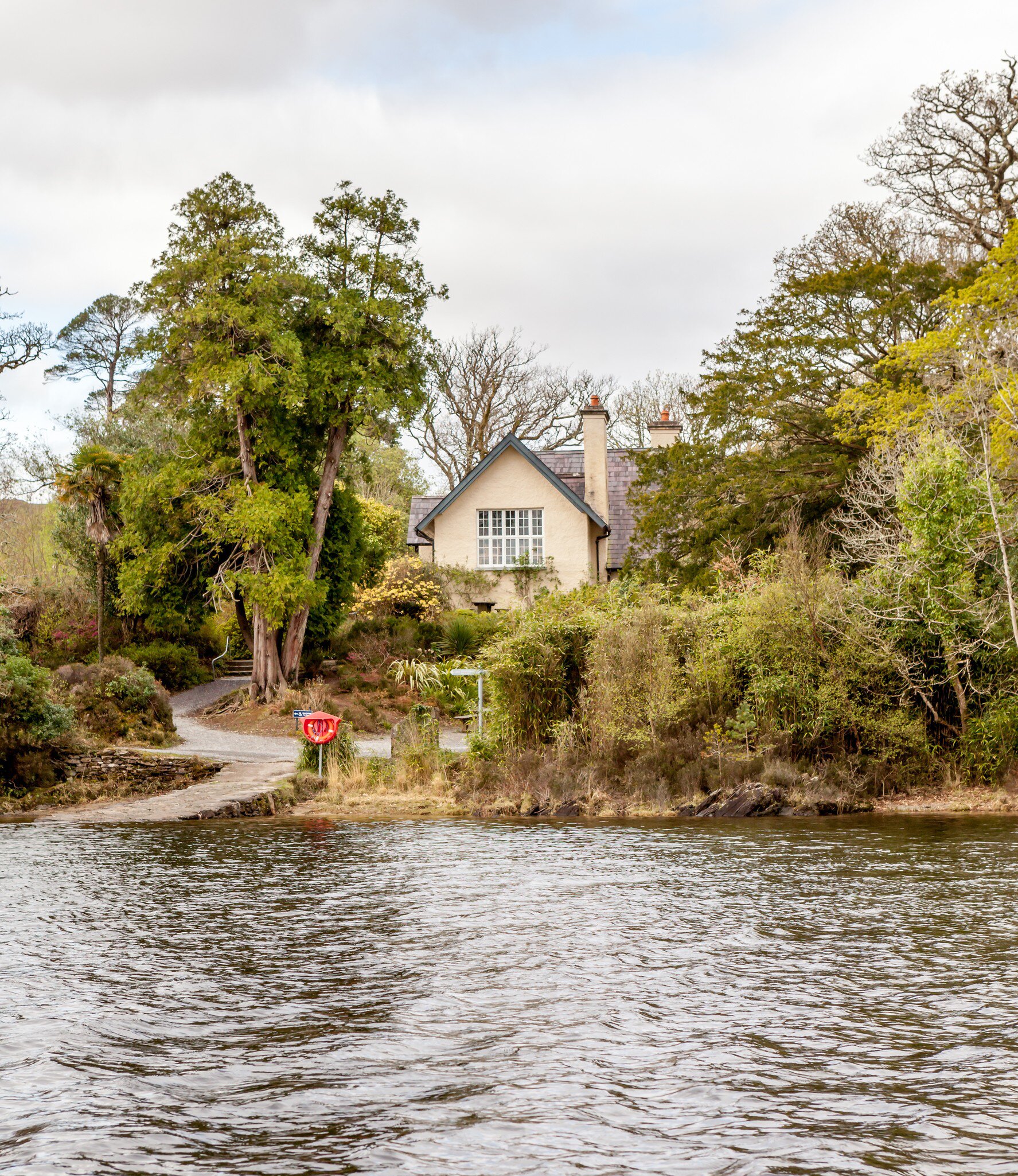 Exterior of Dinis Cottage with trees surrounding, Killarney National Park, County Kerry, Ireland.