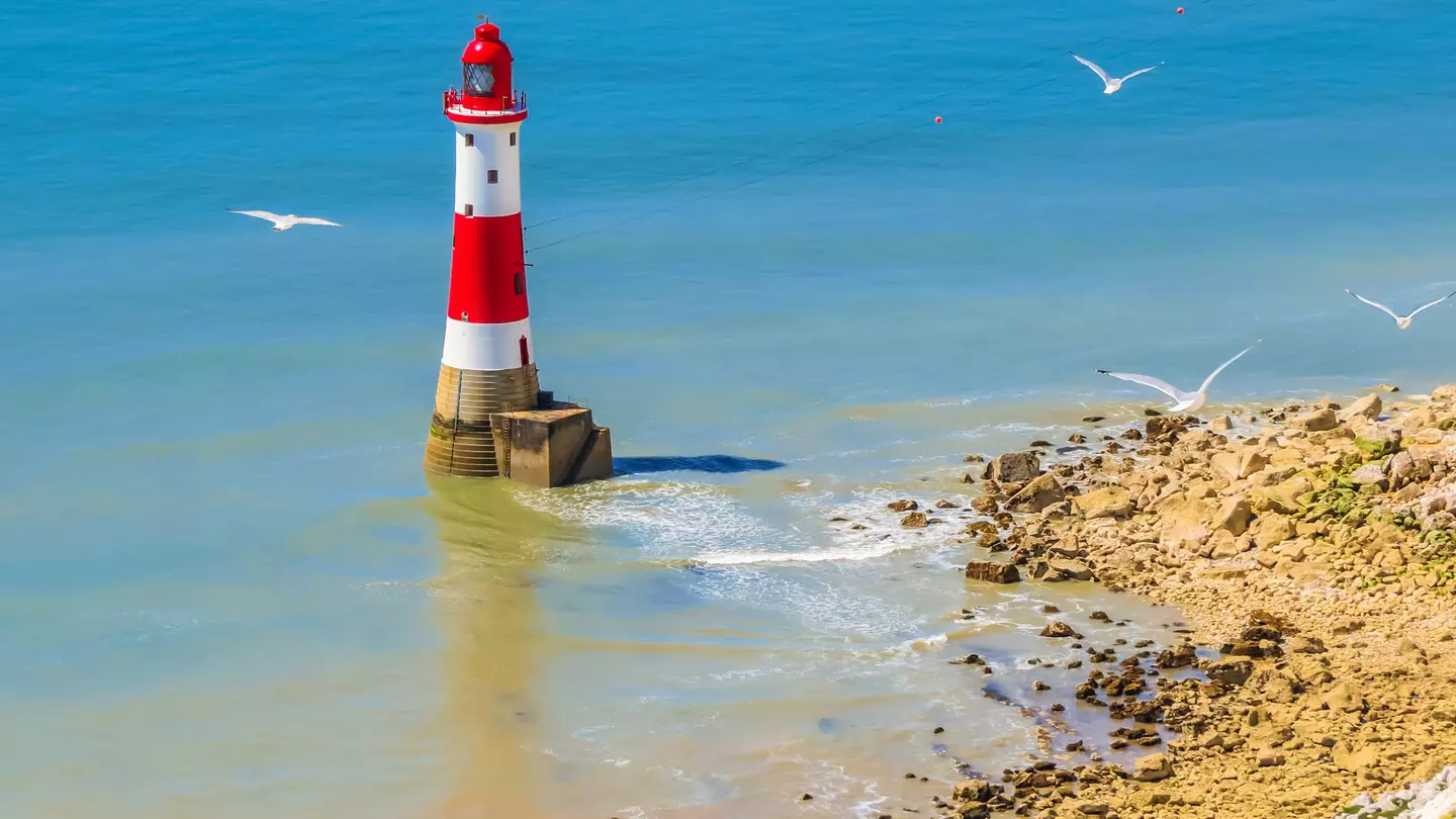 White chalk cliffs and aerial view of Lighthouse Beachy Head