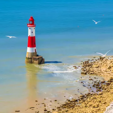 White chalk cliffs and aerial view of Lighthouse Beachy Head