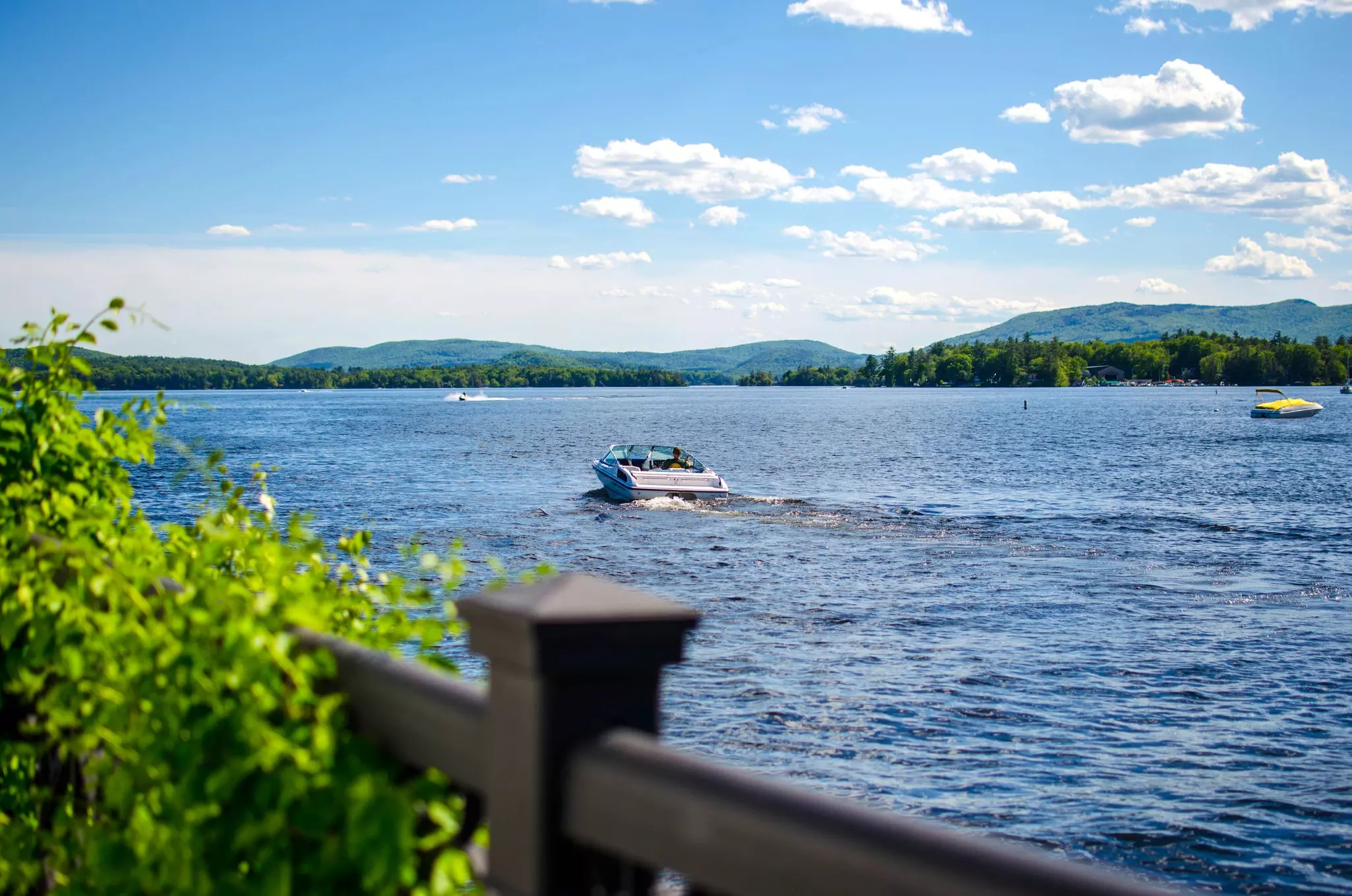 Boat docks on a lake with mountain background. Wolfeboro New Hampshire, License Type: media, Download Time: 2026-04-06T15:08:24.000Z, User: rhylton_redventures, Editorial: false, purchase_order: 65050 - Digital Destinations and Articles, job: Lonely Planet, client: social, other: Rhianydd Hylton