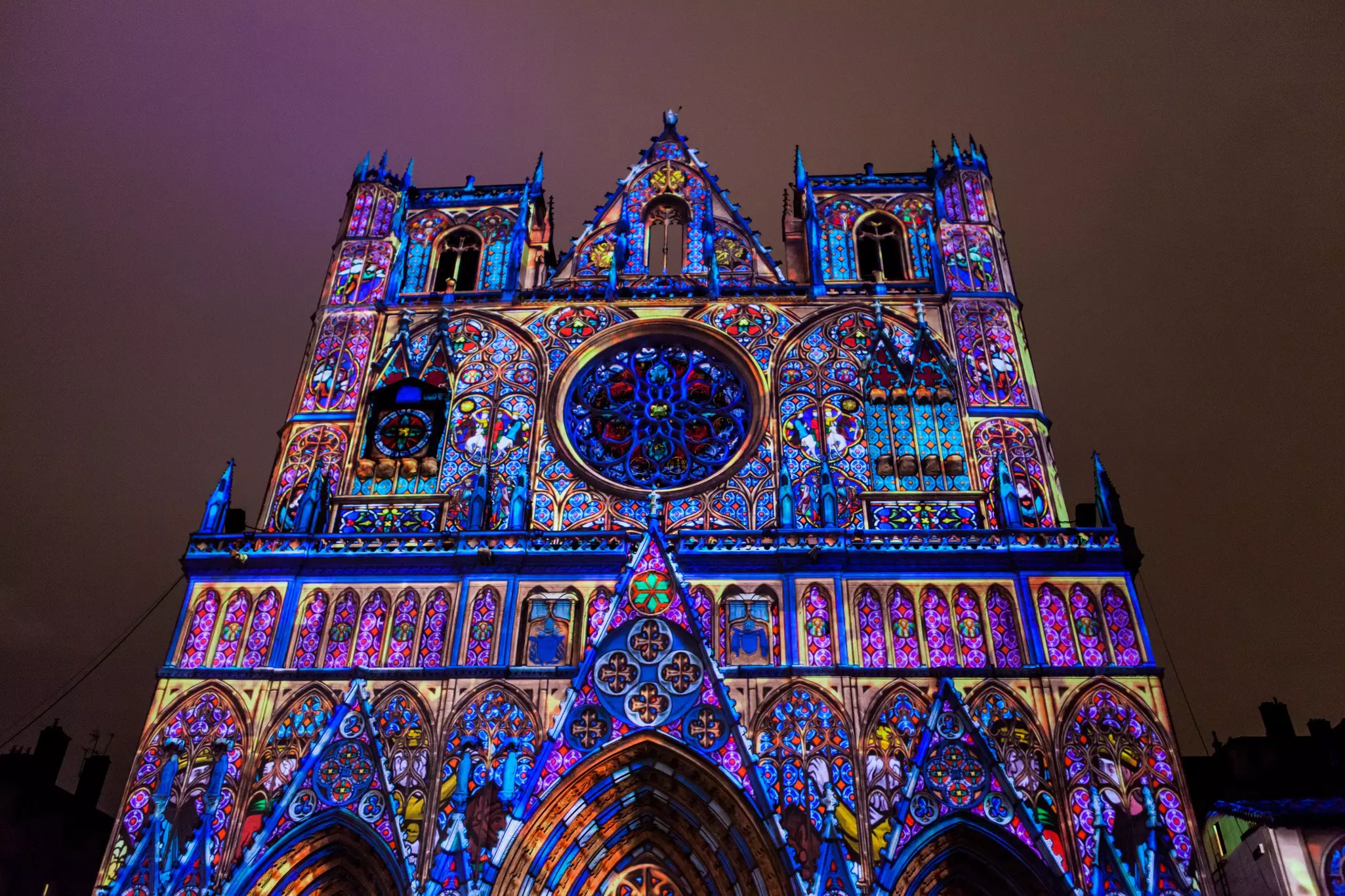 Exterior of Lyon Cathedral, a Roman Catholic cathedral dedicated to Saint John the Baptist, during the Lumiere light festival at night.