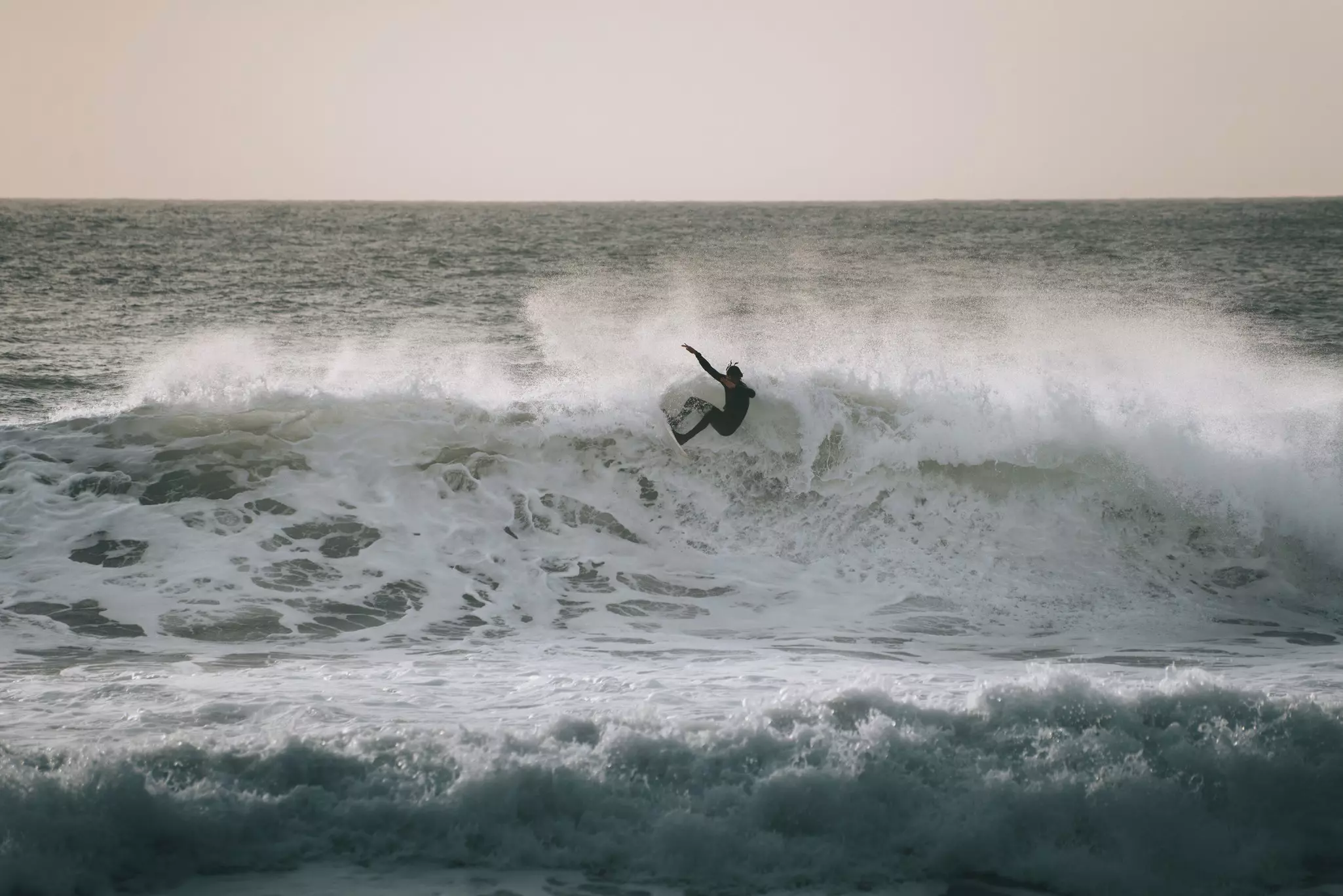 A surfer catching a big wave in Levanto, Liguria, Italy.