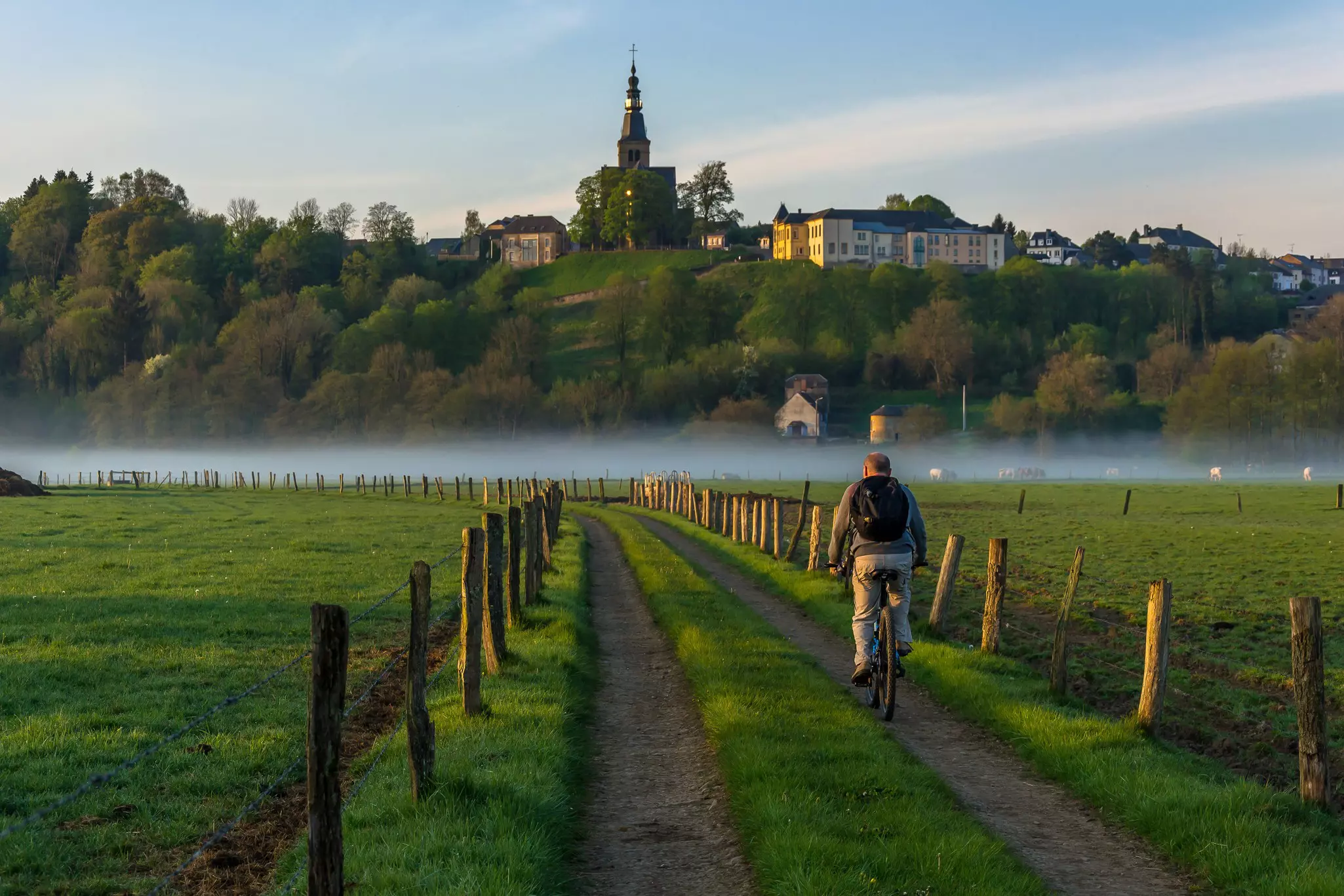 A man on a bicycle enjoying a peaceful sunrise on the border of Belgium with France. A beautiful mist covers the Semois river adding a beautiful touch of light colors in the background; Shutterstock ID 1373035964; purchase_order:65050 - Digital Destinations and Articles; job:Lonely Planet Online Editorial; client:Best things to do in Belgium; other:Brian Healy
1373035964