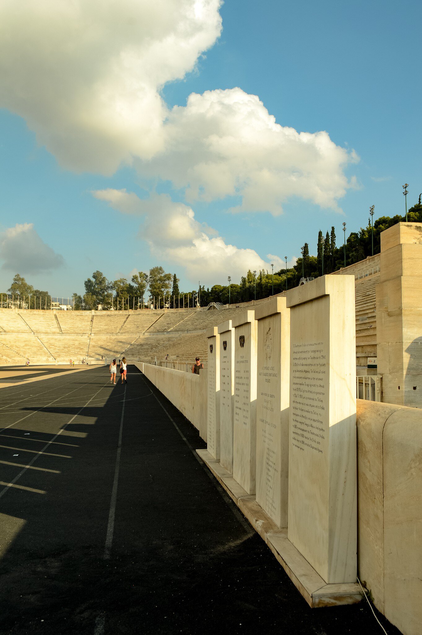 Tourists stroll through the Panathenaic Stadium in Athens, Greece.