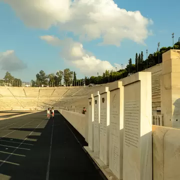 Tourists stroll through the Panathenaic Stadium in Athens, Greece.