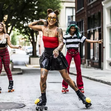 Young women rollerskating in urban area
