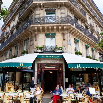Paris, France - June 27, 2012: Cafe Les Deux Magots. Les Deux Magots is a famous caf!AA> in the Saint-Germain-des-Pr!AA>s area of Paris. It once had a reputation as the rendezvous of the literary and intellectual !AA>lite of the city. It is now a popular tourist destination. Parisians and tourists are enjoying a beautiful summer day outside.
458231415
Capital Cities, Paris Left Bank, Residential Structure, Building Exterior, Awning, Color Image, Entrance, Eating, Sidewalk, History, Green, Architecture, Urban Scene, Outdoors, Vertical, People, St-Germain-des-Pres, Latin Quarter, Paris - France, France, Europe, Day, Summer, Sky, Balcony, House, Cafe, Restaurant, Street, Built Structure, Cafe des Deux Magots