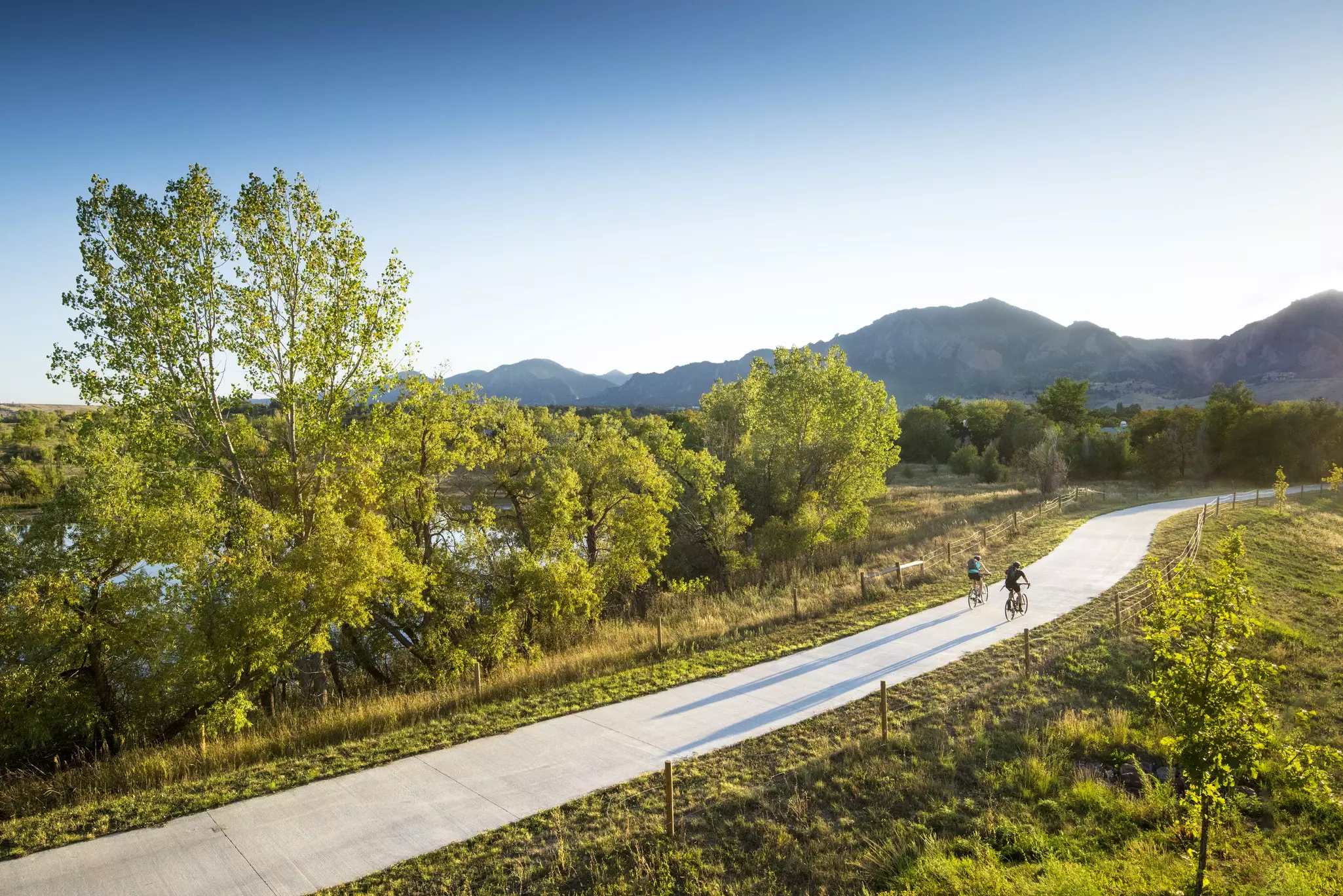 Bicyclists pedal in afternoon sunshine near Boulder