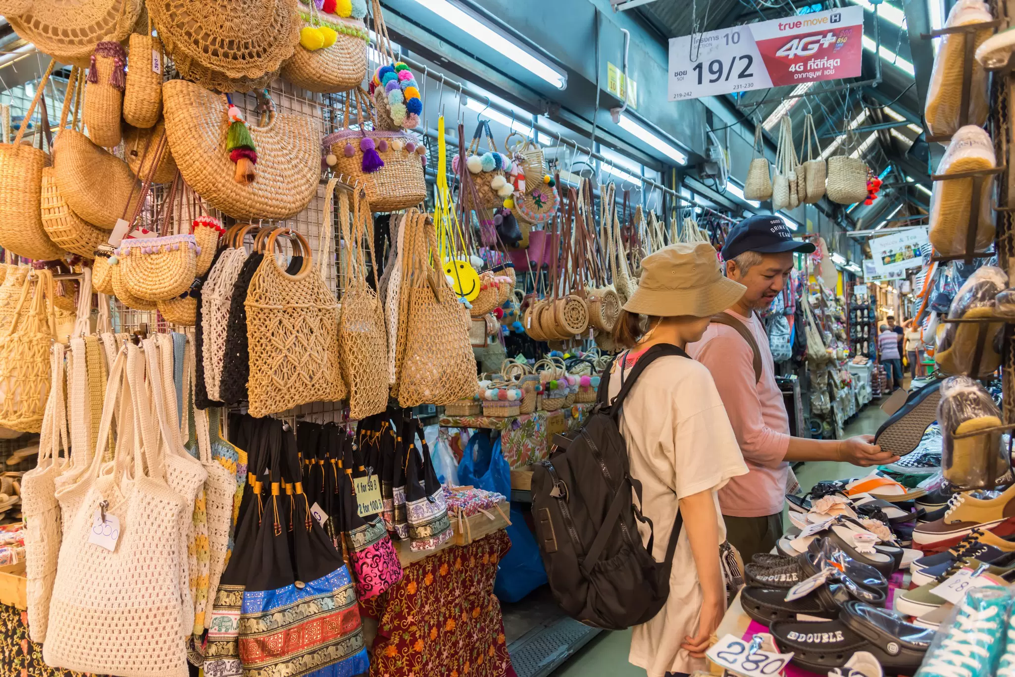 People shopping and exploring around Chatuchak Weekend Market in Bangkok, Thailand.