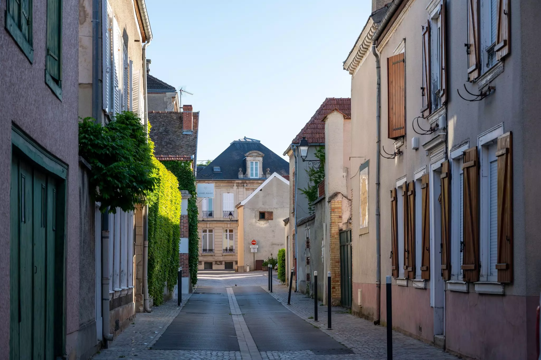 Homes line a narrow street in a historic village.