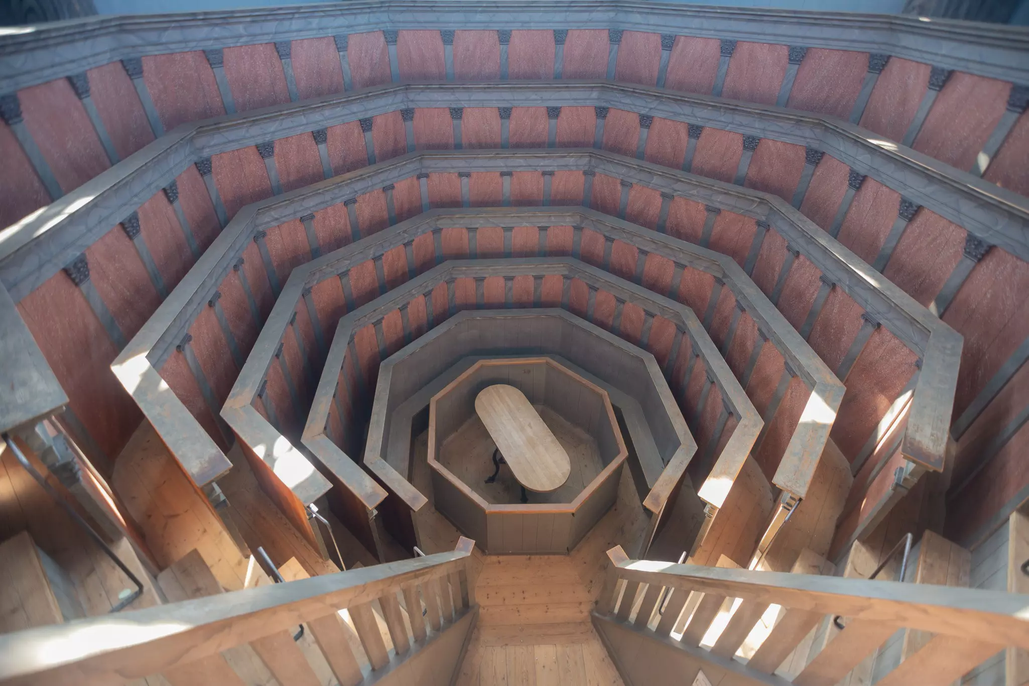 Narrow, steep risers surround a table in a former operating theater.