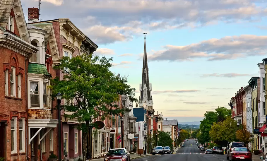 View of houses and cars along Warren Street at dawn in Hudson, New York.
