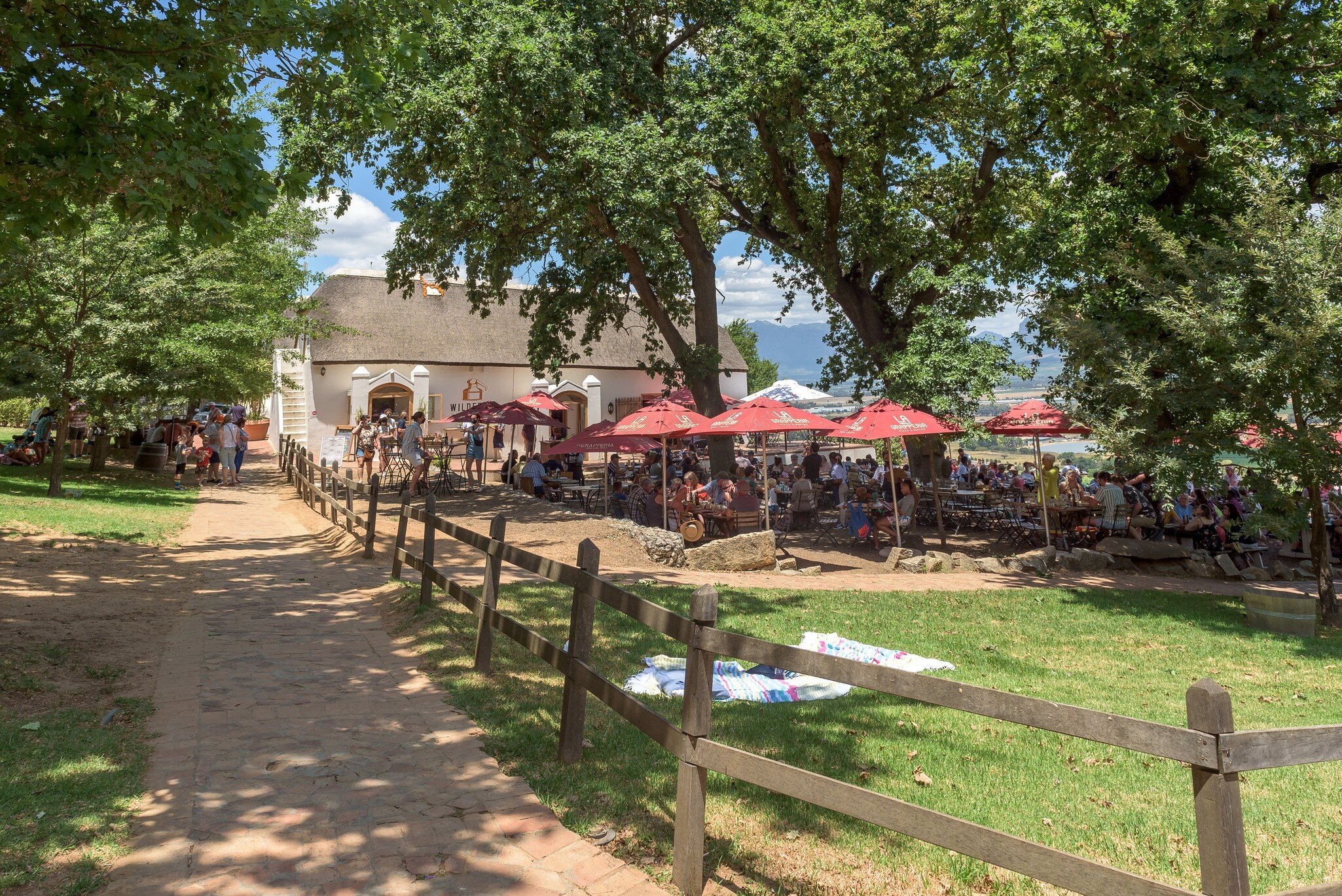 Paarl, South Africa - Dec 26, 2021: Restaurant and picnic area at Spice Route near Paarl in the Western Cape Province. People are visible