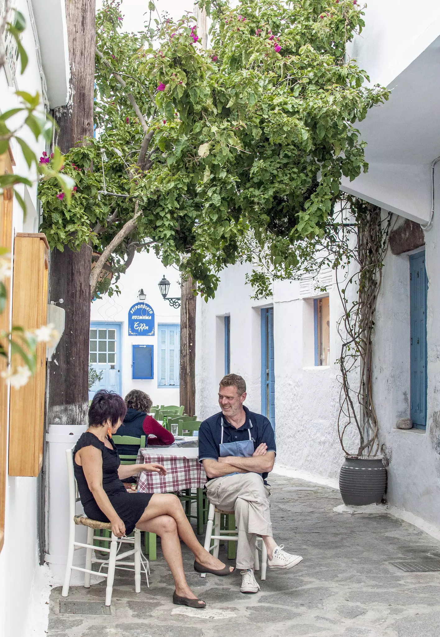People socializing in the Plaka backstreets, Milos, Cyclades islands, Greece
