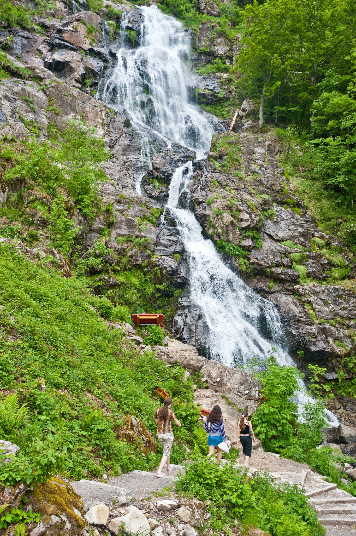 Three women walking by the Todtnauer waterfalls, Todtnau, Black Forest, Baden-Wurttemberg, Germany.