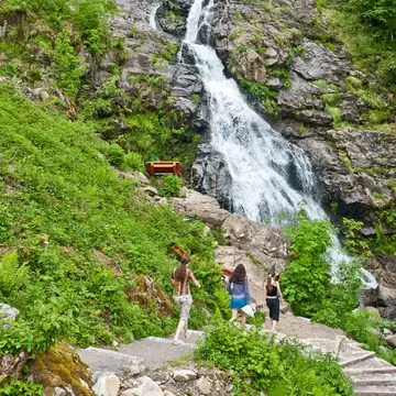 Three women walking by the Todtnauer waterfalls, Todtnau, Black Forest, Baden-Wurttemberg, Germany.