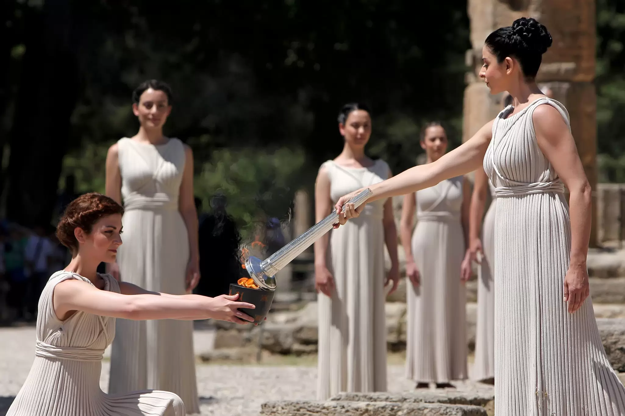High Priestess lighting the Olympic flame during the torch lighting ceremony at ancient Olympia for the 2012 London Olympic Games.