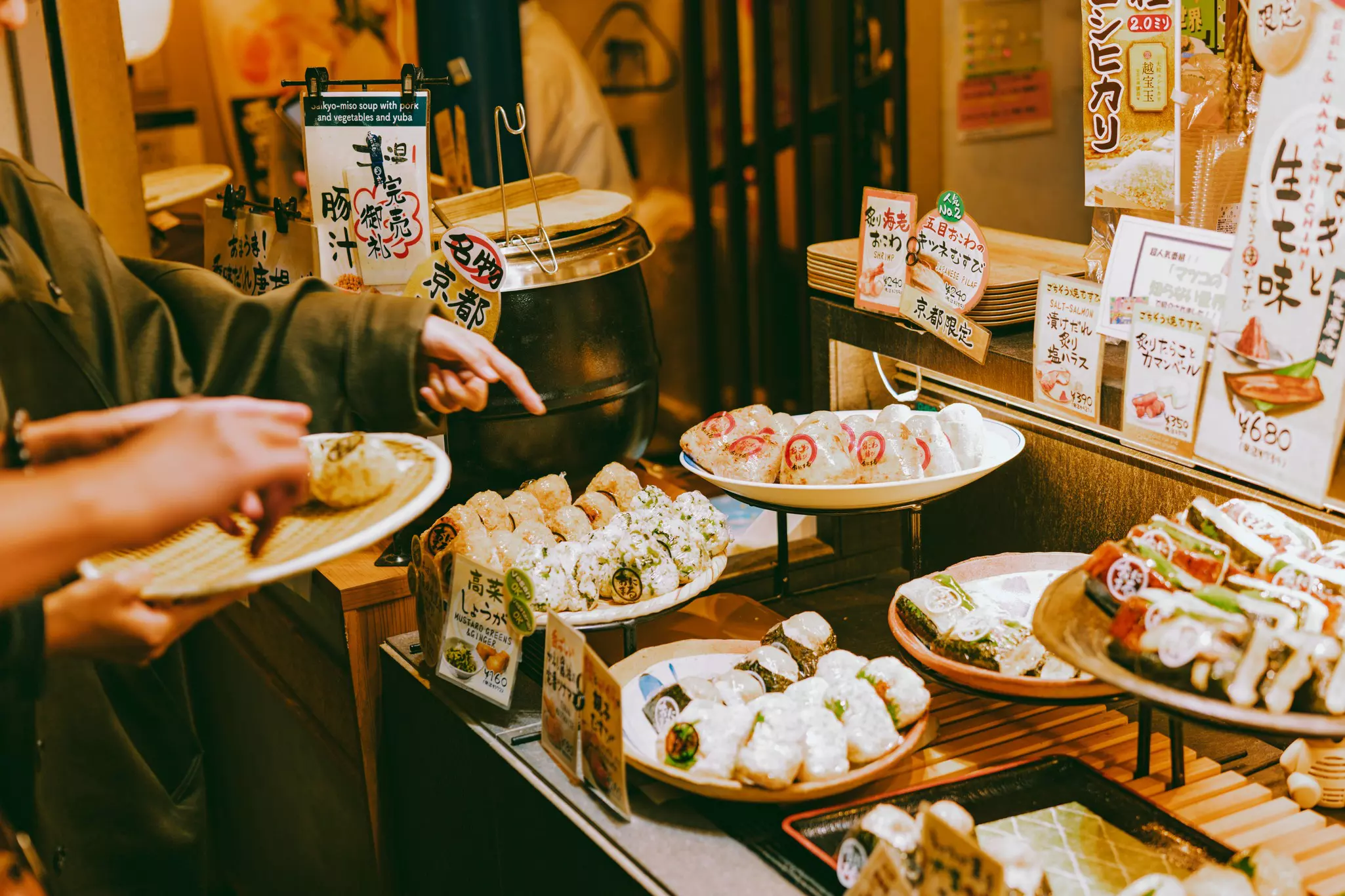 A customer points at Japanese produce for sale at a market stall