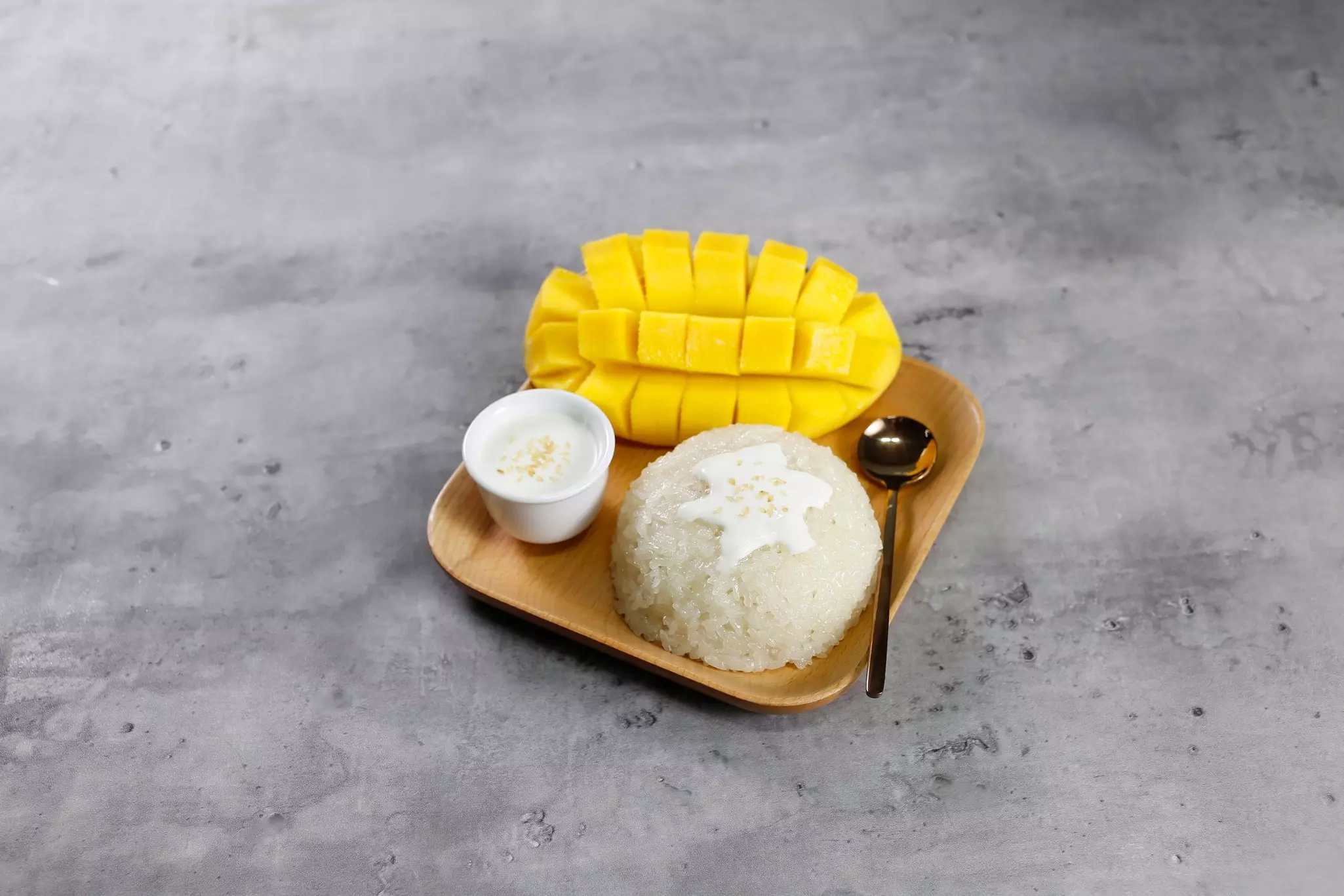 Mango sticky rice dessert Thai food with Ripe Mango tropical fruit on bamboo plate