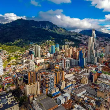 Bogota cityscape of big buildings and mountains and blue sky