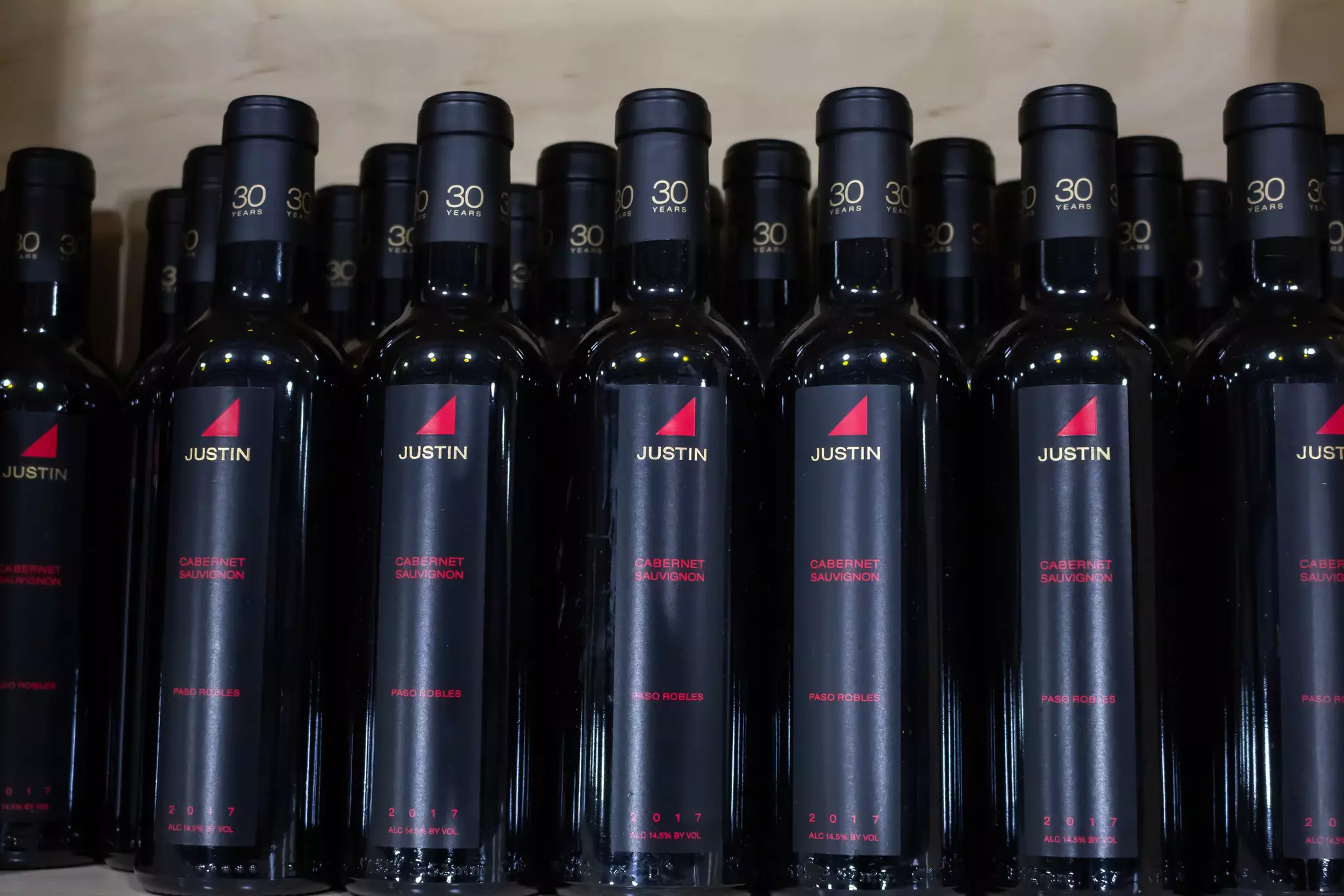 Wine in black bottles arranged in rows