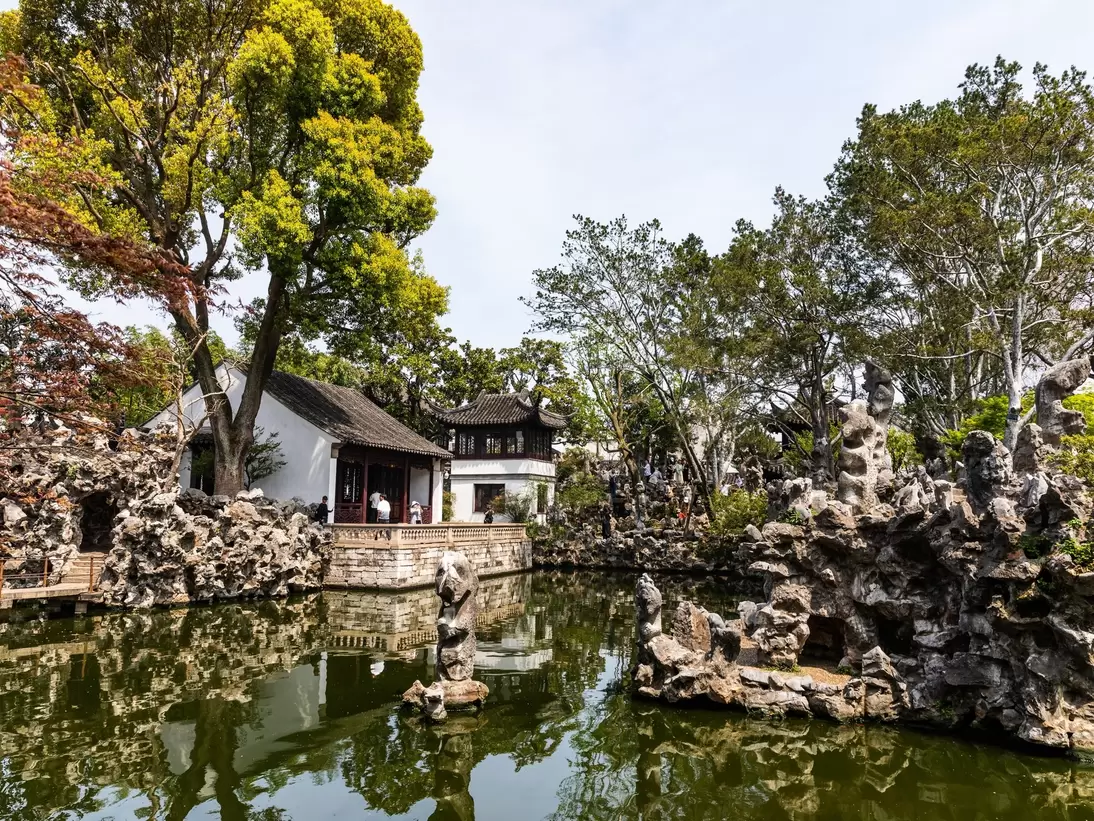 Traditional Chinese pavilion with ornate roof in Suzhou Lion Grove Garden, surrounded by scenic rock formations and lush trees reflected in tranquil pond waters., License Type: media, Download Time: 2026-09-01T19:13:49.000Z, User: LP_NZhan, Editorial: false, purchase_order: 65050 - Digital Destinations and Articles, job: App Content, client: Lonely Planet App, other: Nadine Zhan