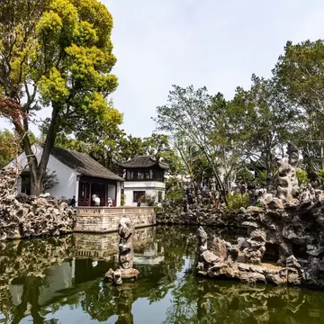 Traditional Chinese pavilion with ornate roof in Suzhou Lion Grove Garden, surrounded by scenic rock formations and lush trees reflected in tranquil pond waters., License Type: media, Download Time: 2026-09-01T19:13:49.000Z, User: LP_NZhan, Editorial: false, purchase_order: 65050 - Digital Destinations and Articles, job: App Content, client: Lonely Planet App, other: Nadine Zhan