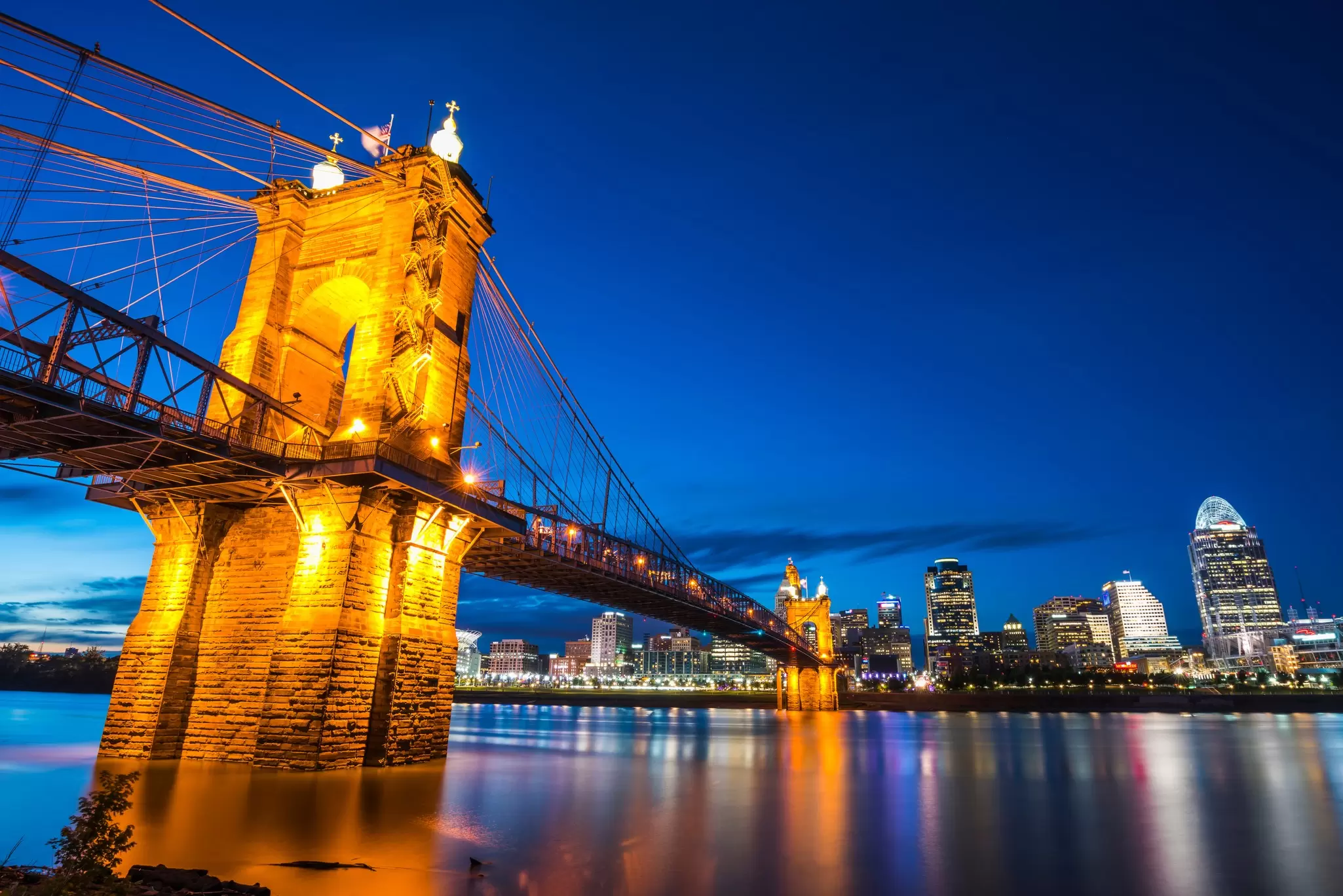 The John A Roebling Suspension Bridge lit up at night in Cincinnati, Ohio