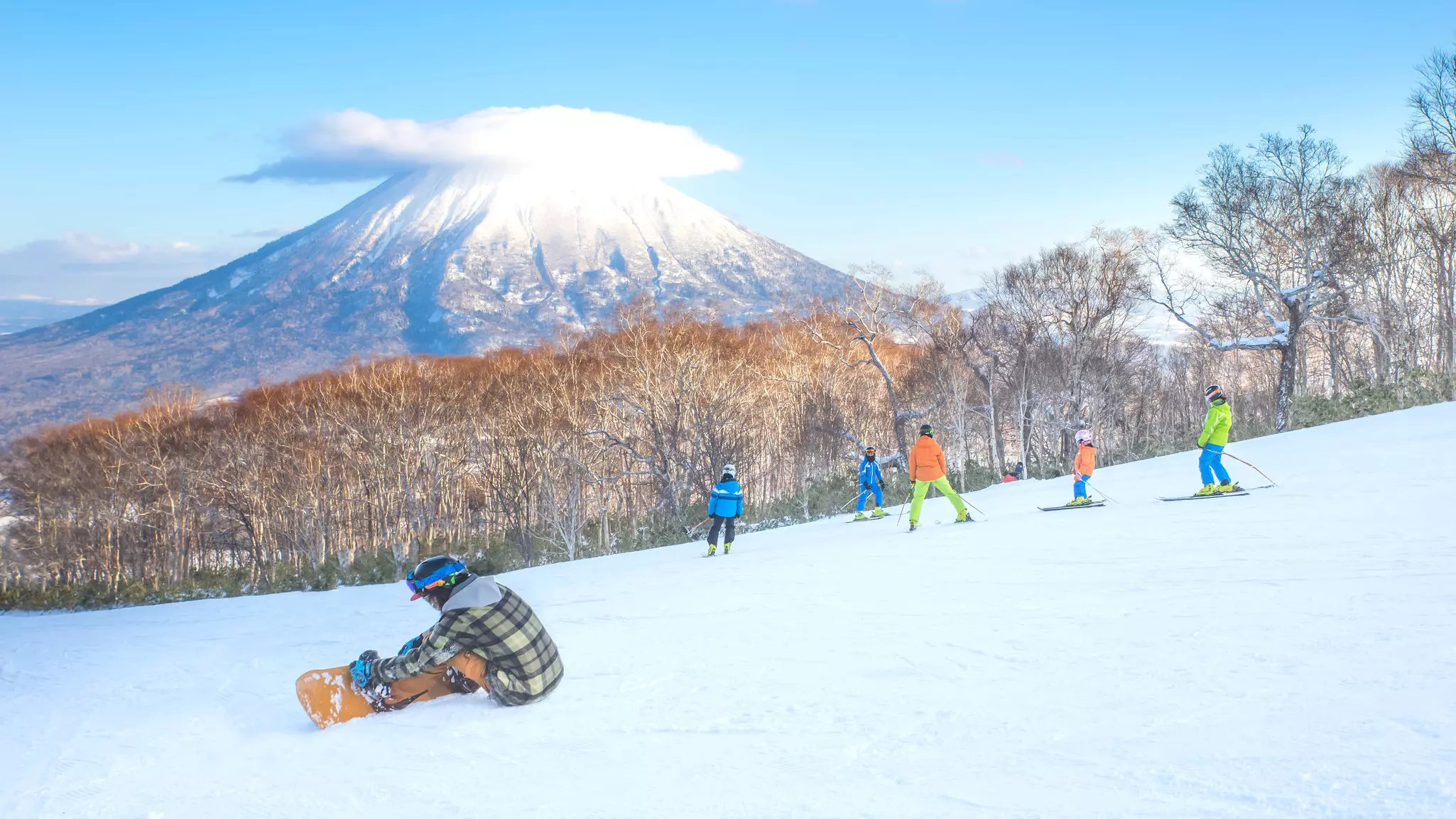 People skiing with Mt Yotei as a background in Niseko Ski area, Hokkaido, Japan