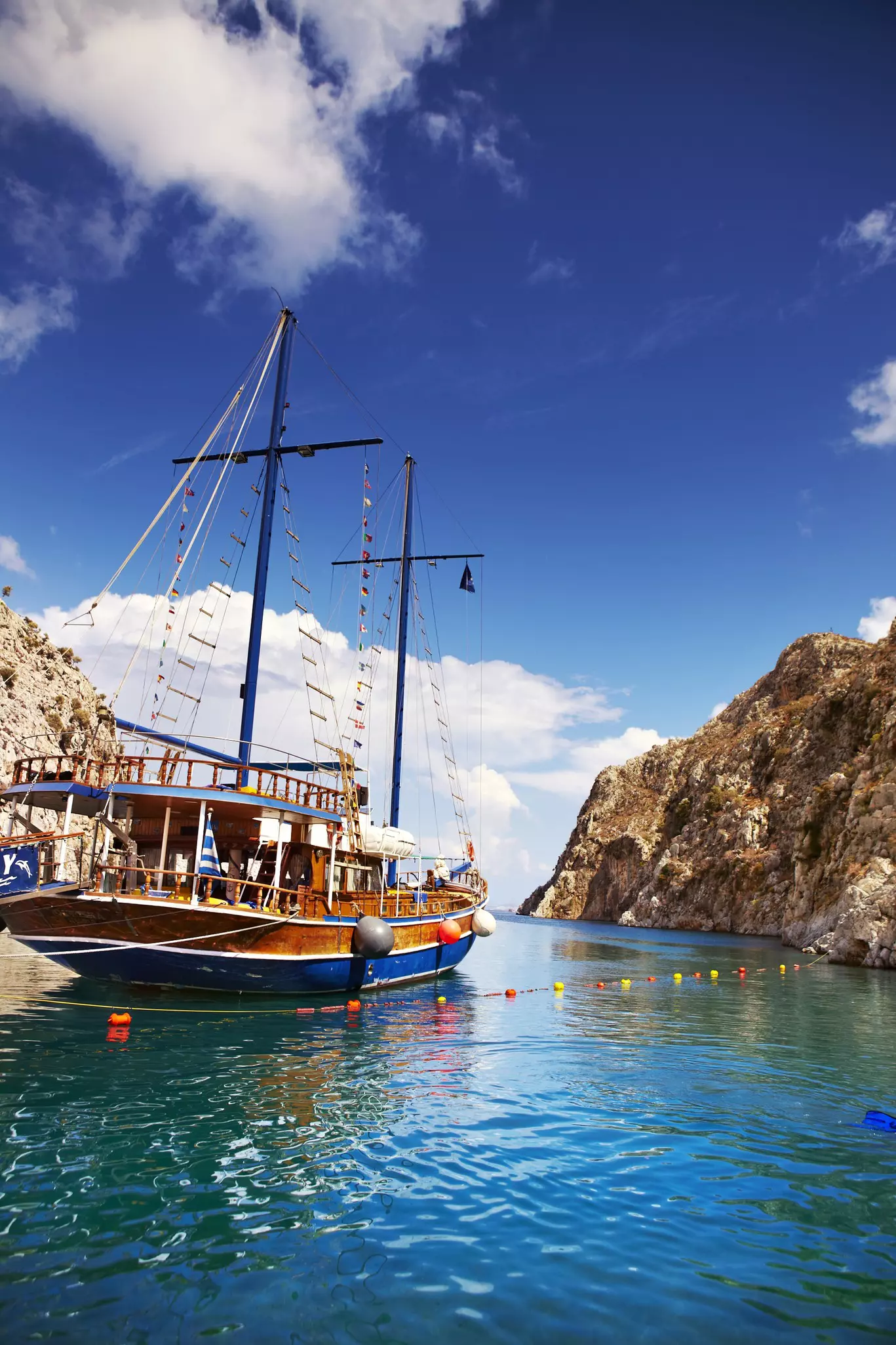 Island-hopping yacht moored in secluded cove.