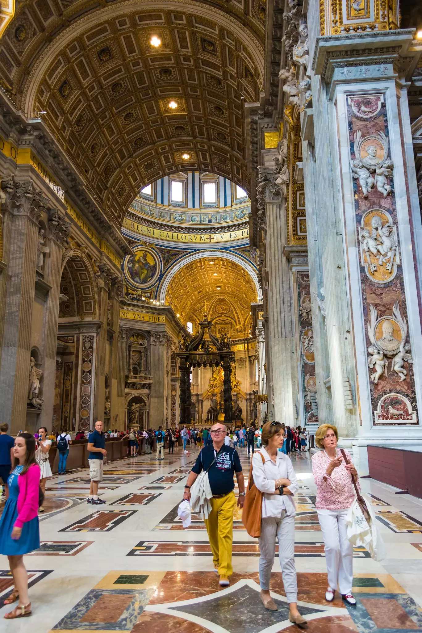 Visitors walking inside St. Peter's Basilica in the Vatican City in Rome, Italy.