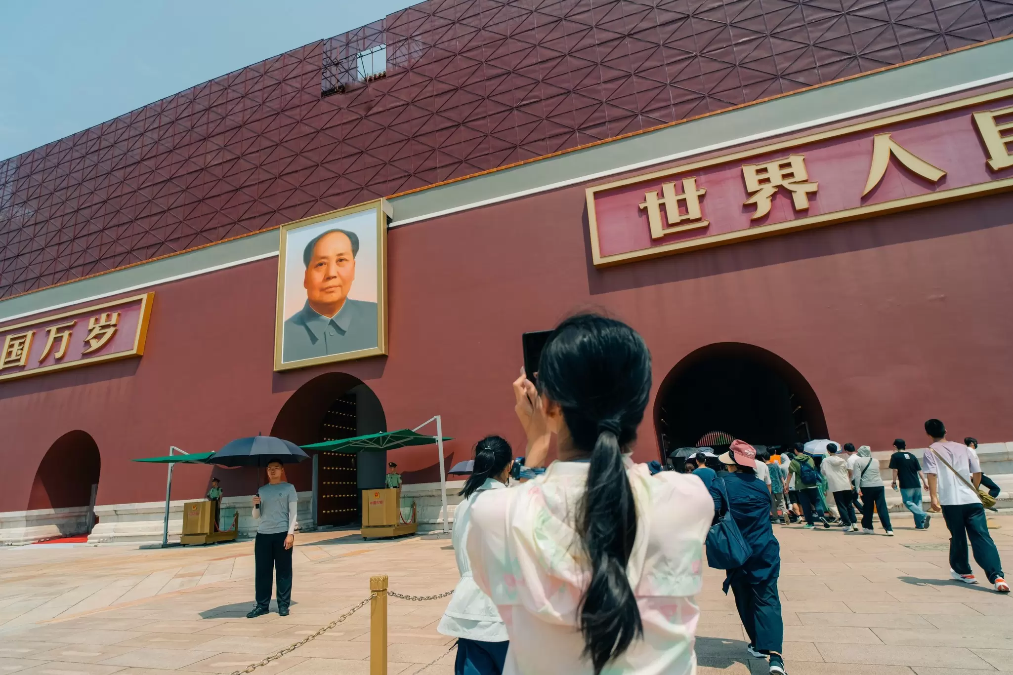 A visitor takes a photo of Tiananmen Square on a sunny day in Beijing, China.