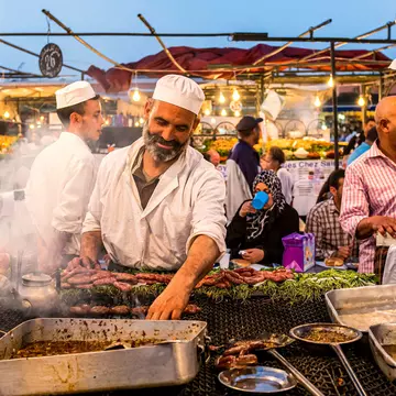 A cook at a food stall in Jemaa el-Fnaa, the main square of Marrakesh, Morocco.