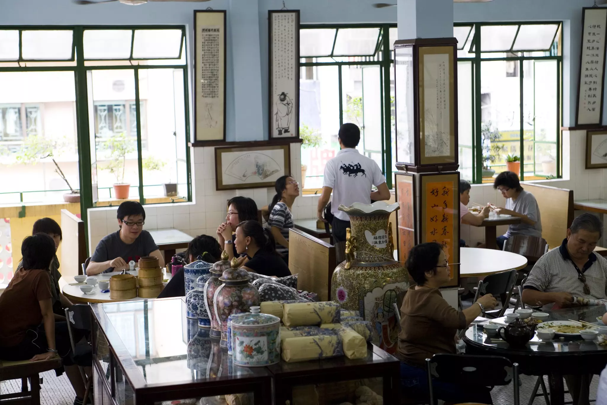 People dining at a tea house with light streaming through the windows