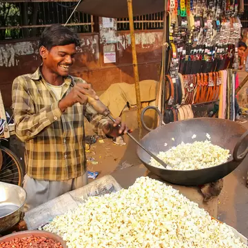 Unidentified man sells popcorn at Kinari Bazaar on November 10, 2014 in Agra, India.