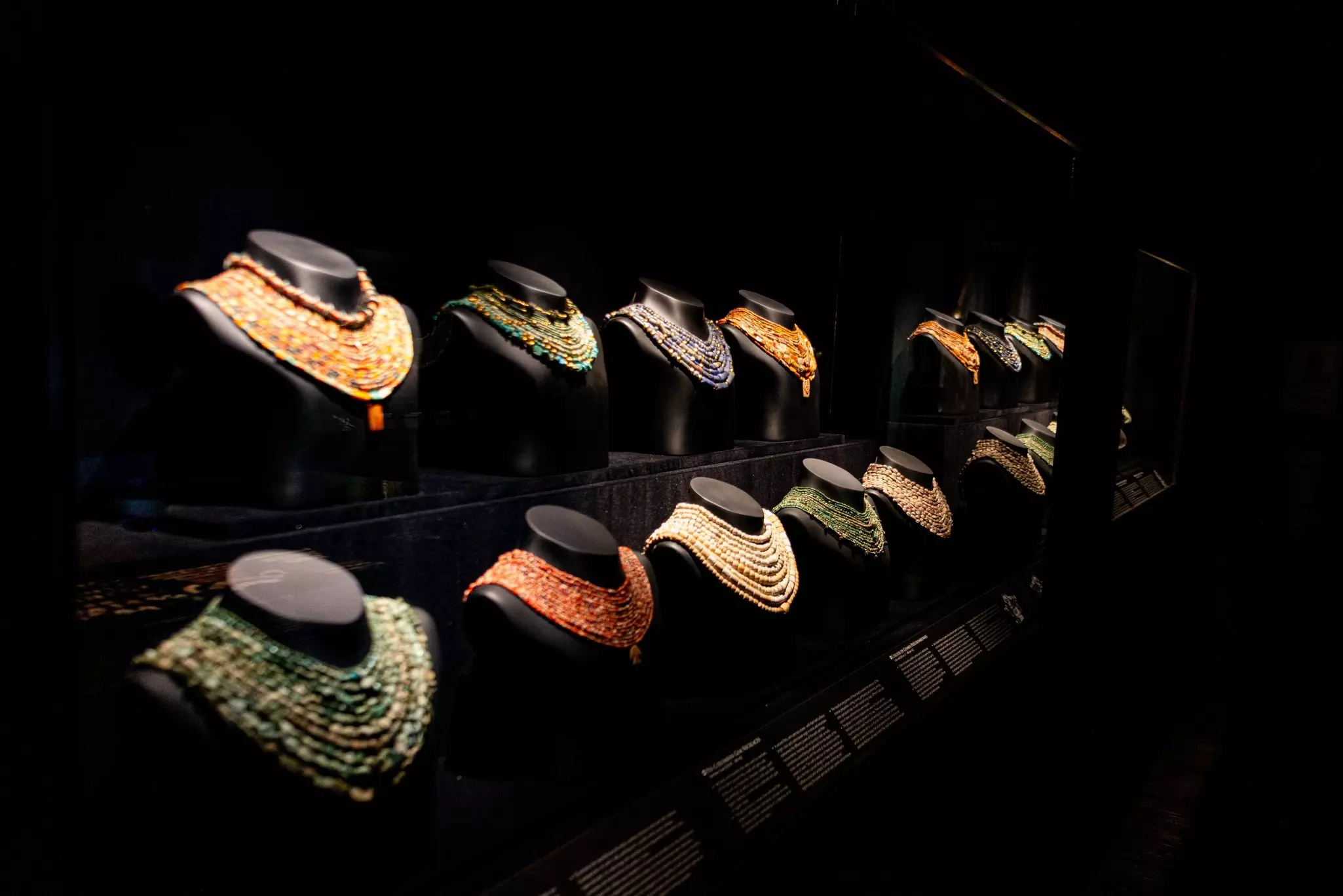A display of elaborate jewelry in a museum showcase.