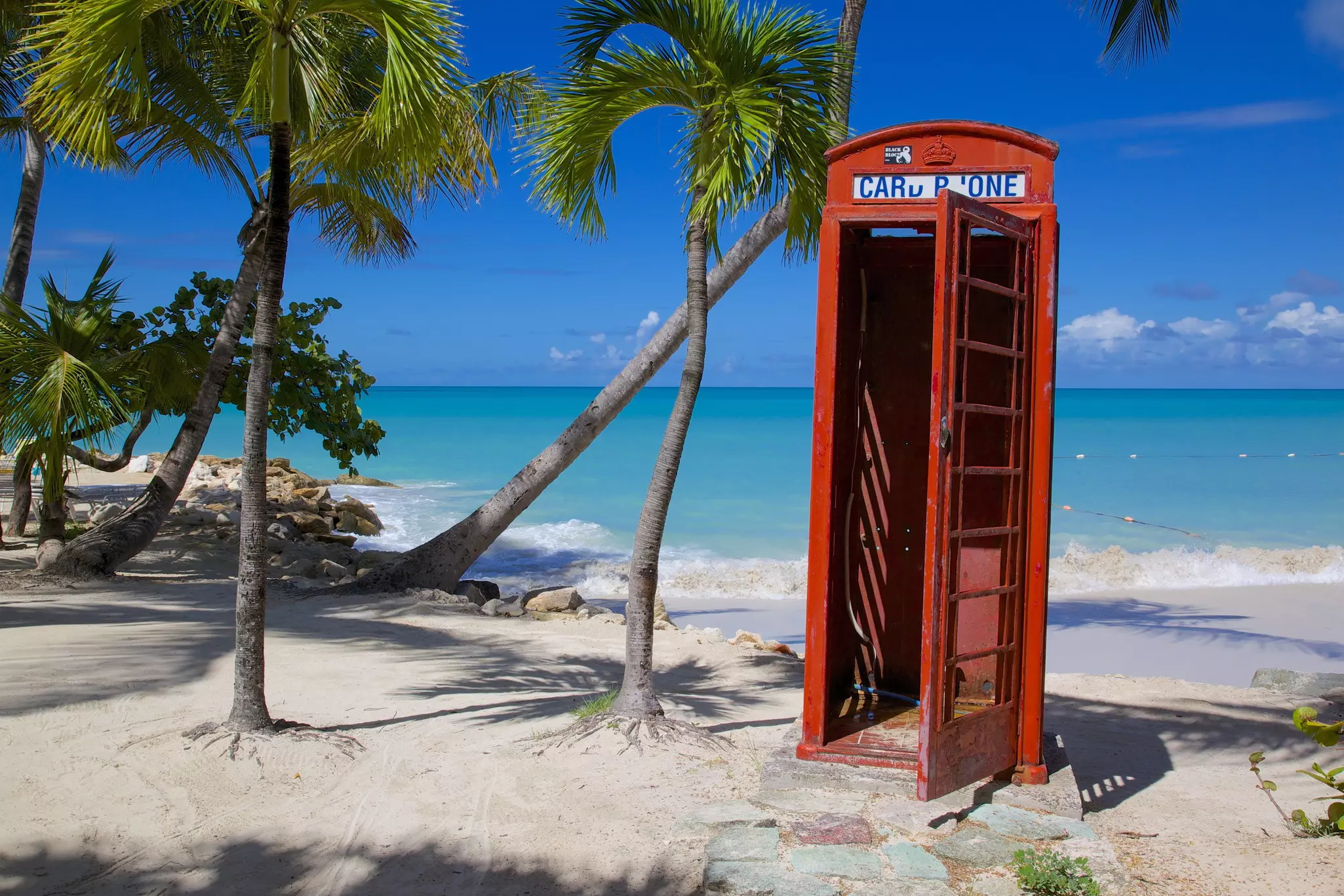 Beach and red telephone box, Dickenson Bay, St. Georges, Antigua, Leeward Islands, West Indies, Caribbean, Central America