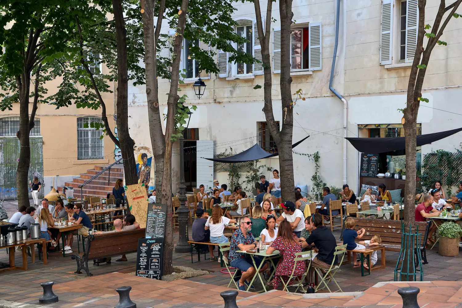 People sitting on outdoor restaurant terraces in Marseille, Bouches-du-Rhône, France