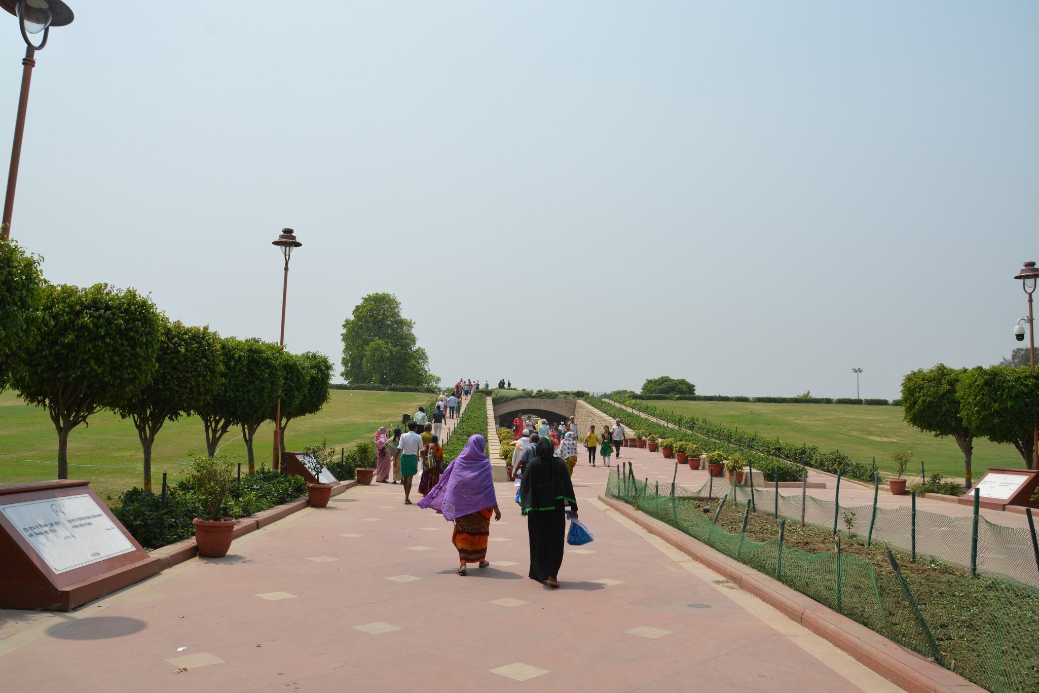 Women walking through the Gandhi Mausoleum, Raj Ghat, New Delhi, India.