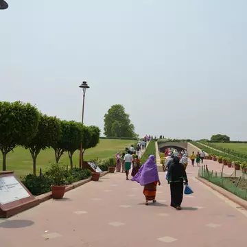 Women walking through the Gandhi Mausoleum, Raj Ghat, New Delhi, India.