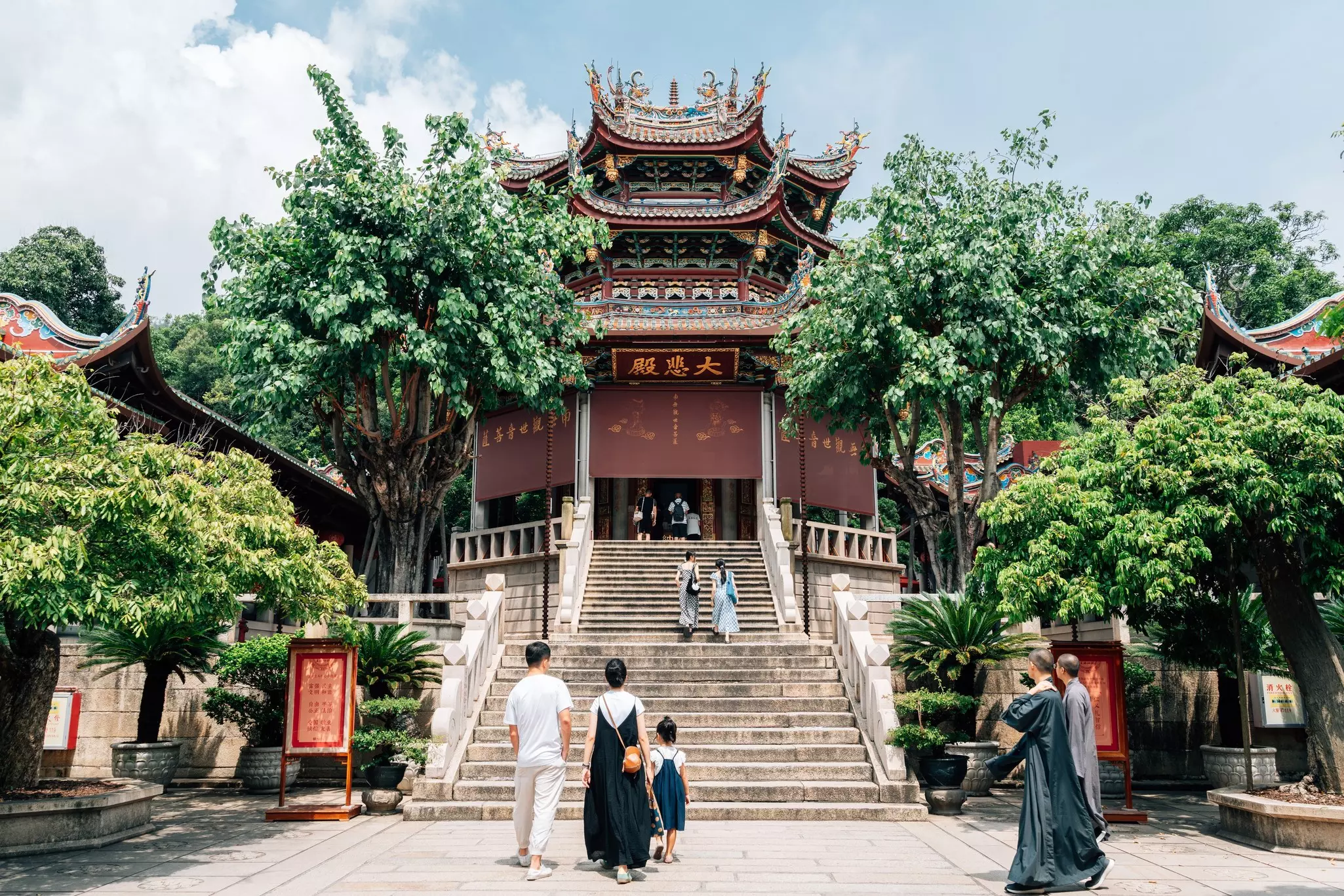 Visitors approach the steps to a temple in Xiamen.
